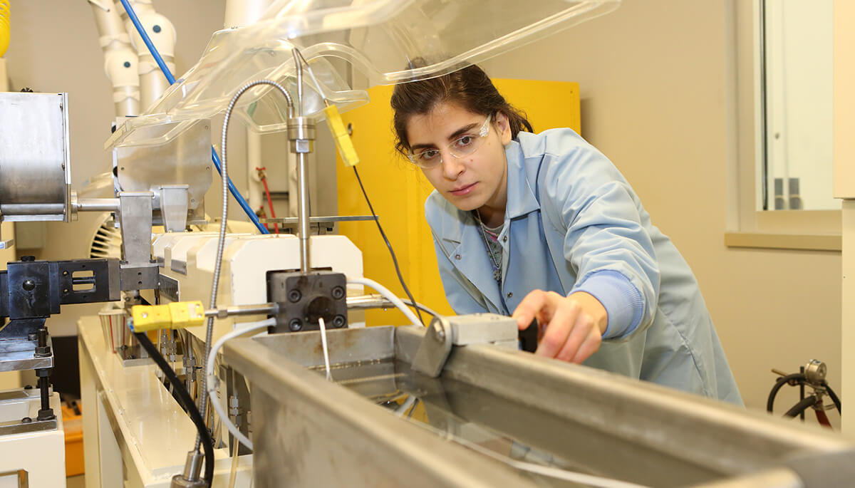 Plastics processing student in a lab