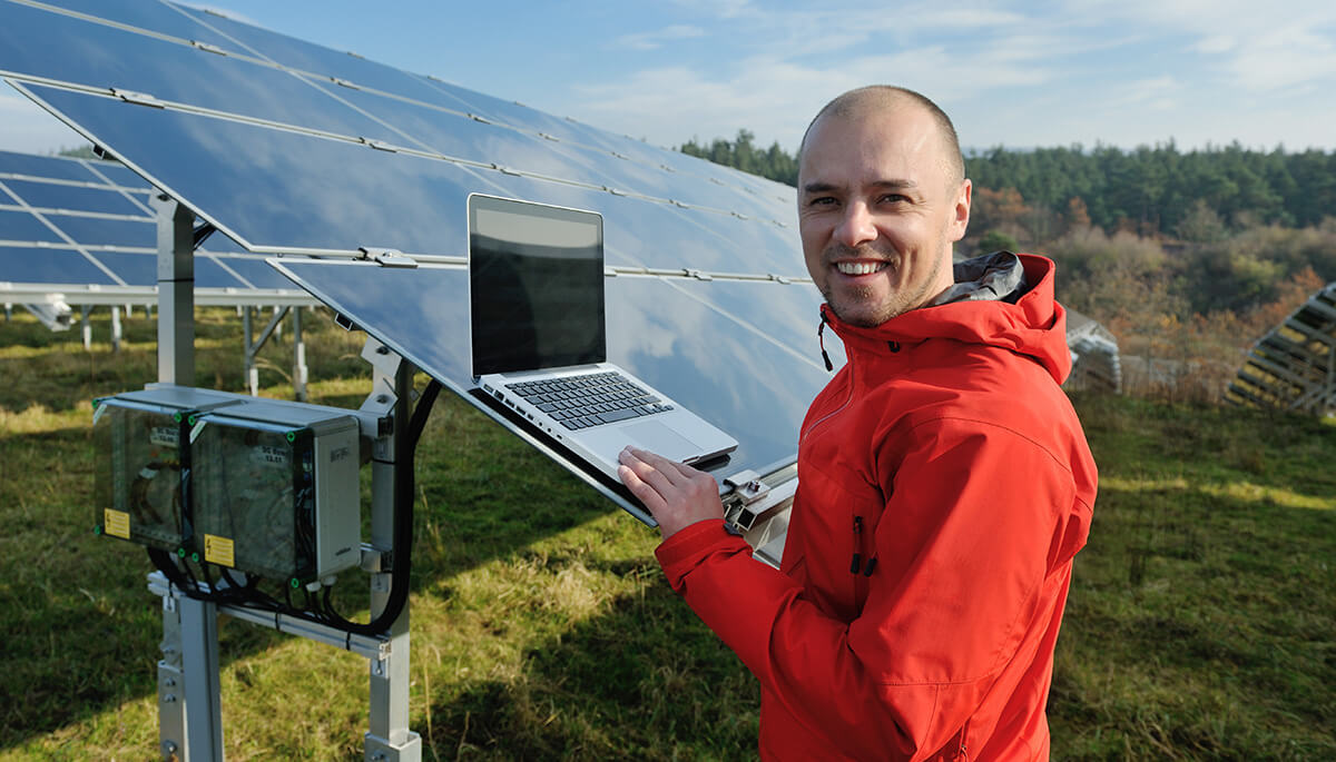 Renewable energy engineering student by a solar panel 