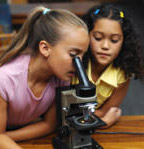 kids looking through microscope