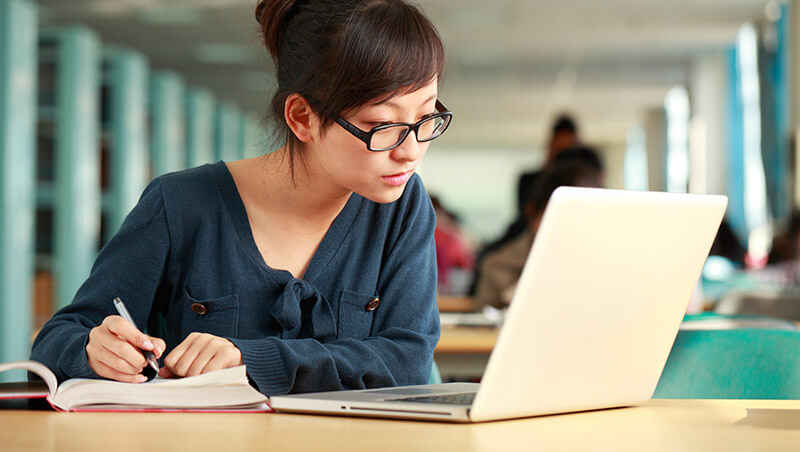 girl on a laptop in library