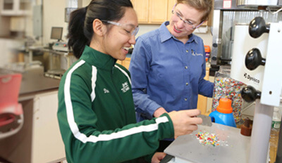 Two plastics engineering students in the lab.