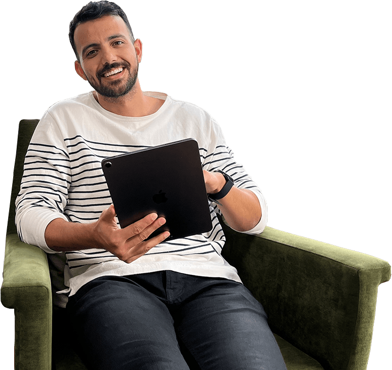 An online student looking at his class schedule in his living room.