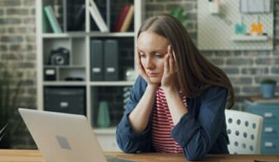 A woman at work at home under stress