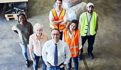 A group of happy workers in a warehouse.