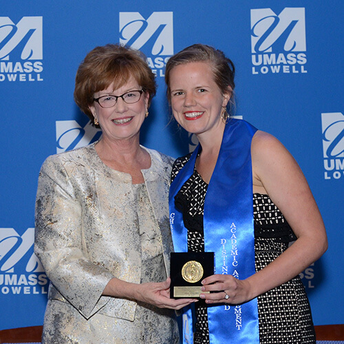 Abby Koljonen poses with the chancellor with her medal for academic acheivement