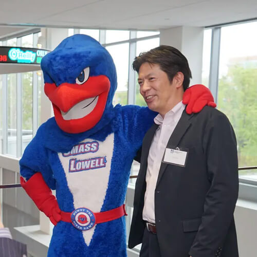 Abitus MBA student Seiji Sado poses for a picture with Rowdy during a luncheon at the Pulichino Tong Business Center on Commencement eve.